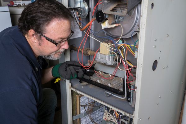 Our team members fixing heating and furnace unit in Marin County CA